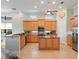Spacious kitchen featuring stainless steel appliances, tile flooring and an island at 9335 San Jose Blvd, Howey In The Hills, FL 34737