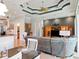 Open-concept living room with a tray ceiling, fan, and tile flooring throughout at 9335 San Jose Blvd, Howey In The Hills, FL 34737