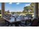 Elegant outdoor dining area overlooking a scenic golf course and lake with lush landscaping at 9335 San Jose Blvd, Howey In The Hills, FL 34737