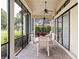 Relaxing screened patio with brick flooring, ceiling fan, and comfortable seating and view of lush green yard at 9335 San Jose Blvd, Howey In The Hills, FL 34737