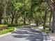 Scenic street lined with mature trees and lush greenery in a quiet neighborhood at 9335 San Jose Blvd, Howey In The Hills, FL 34737