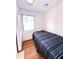 Small bedroom featuring a large window, wood floors, and a cozy space ideal for relaxation at 100 W Idlewild Ave, Eustis, FL 32726
