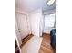 Cozy bedroom features ample natural light, light hardwood floors, double closet doors, and entry door at 100 W Idlewild Ave, Eustis, FL 32726
