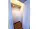 Closet with hanging rods, hardwood floor, and access door to the side at 100 W Idlewild Ave, Eustis, FL 32726