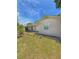 View of home with grassy front yard, enhanced by mature trees and flowering bushes at 100 W Idlewild Ave, Eustis, FL 32726