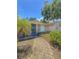 Charming entrance with blue door, and paved walkway surrounded by lush landscaping at 100 W Idlewild Ave, Eustis, FL 32726