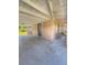 Spacious covered patio featuring concrete flooring, adjacent outdoor space, and exterior brick accents at 100 W Idlewild Ave, Eustis, FL 32726