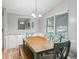 Bright dining room includes a chandelier, built in storage and views of the landscaped yard from a large window at 1005 Richard Dr, The Villages, FL 32159