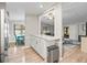 Open kitchen view with ample counter space, stainless steel trash can, and an open view of the living and dining rooms at 1005 Richard Dr, The Villages, FL 32159