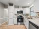 Well-equipped kitchen featuring stainless steel appliances, white cabinets, and a tiled backsplash at 1005 Richard Dr, The Villages, FL 32159