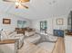 Inviting living room featuring neutral tones, modern decor, and sliding glass doors to the screened in lanai at 1005 Richard Dr, The Villages, FL 32159