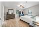Serene main bedroom with light wood floors, ceiling fan and two large windows allowing plenty of natural light at 1005 Richard Dr, The Villages, FL 32159
