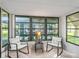 Comfortable sunroom featuring neutral decor and ample seating, perfect for relaxing or entertaining guests at 1005 Richard Dr, The Villages, FL 32159