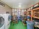 Roomy utility room with washer/dryer, storage shelves, and ample open space at 1005 Richard Dr, The Villages, FL 32159