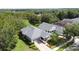 Overhead view of two homes with green lawns, trees, and a well-manicured landscape at 101 Flame Vine Way, Groveland, FL 34736