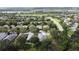 An aerial view showcasing houses in a lush, wooded neighborhood at 101 Flame Vine Way, Groveland, FL 34736