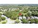 Aerial view of a well-maintained home nestled in a peaceful community with tree-lined streets at 101 Flame Vine Way, Groveland, FL 34736