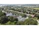 An aerial view of houses with mature trees in a well-maintained community at 101 Flame Vine Way, Groveland, FL 34736