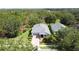 Aerial view of a well-maintained home with landscaping in a lush, wooded community at 101 Flame Vine Way, Groveland, FL 34736