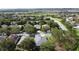 Aerial shot of a well-maintained community with houses amid lush green trees and landscaping at 101 Flame Vine Way, Groveland, FL 34736