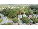 Overhead shot of a home on a tree lined street with well-kept front yard in an established community at 101 Flame Vine Way, Groveland, FL 34736