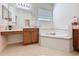 Bathroom with large soaking tub, tile floor and vanity at 101 Flame Vine Way, Groveland, FL 34736