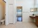Bathroom showing tile floor, vanity with drawers, walk-in closet and doorway to bedroom at 101 Flame Vine Way, Groveland, FL 34736