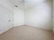 Bedroom featuring tile floors, large closet and ceiling fan at 101 Flame Vine Way, Groveland, FL 34736