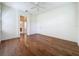 Bright bedroom features hardwood floors, a ceiling fan, and ensuite bathroom access at 101 Flame Vine Way, Groveland, FL 34736