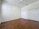 Bright bedroom with beautiful wood floors, ceiling fan and closet at 101 Flame Vine Way, Groveland, FL 34736
