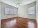 Spacious bedroom with wood floors, windows, and plenty of natural light at 101 Flame Vine Way, Groveland, FL 34736