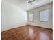 Bedroom features wood floors, 2 windows, and ceiling fan at 101 Flame Vine Way, Groveland, FL 34736