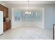 Bright dining area featuring tile floors, a bay window with shutters, and a chandelier at 101 Flame Vine Way, Groveland, FL 34736