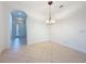 Dining room featuring an arched entrance, chandelier, and tile flooring at 101 Flame Vine Way, Groveland, FL 34736