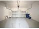Spacious two car garage with clean flooring and door, ready for your vehicles at 101 Flame Vine Way, Groveland, FL 34736