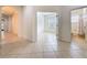 Bright hallway with tile flooring leading to a bedroom and bathroom at 101 Flame Vine Way, Groveland, FL 34736