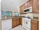 Kitchen view featuring stainless steel appliances, tile floors and natural light from breakfast bar at 101 Flame Vine Way, Groveland, FL 34736