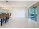 Open kitchen featuring tile flooring, island seating, and sliding glass doors at 101 Flame Vine Way, Groveland, FL 34736