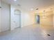 Open-concept living room featuring neutral walls and tiled flooring throughout at 101 Flame Vine Way, Groveland, FL 34736