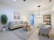 Bright living room with a neutral color palette, tile flooring and ample natural light at 101 Flame Vine Way, Groveland, FL 34736