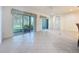 Open living space featuring tile flooring, sliding doors to the patio, and neutral walls at 101 Flame Vine Way, Groveland, FL 34736