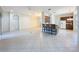 Open concept with breakfast bar separating the kitchen and living space, all with tile flooring at 101 Flame Vine Way, Groveland, FL 34736