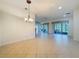 Open living space featuring tile flooring, view of the outdoor space, and modern lighting at 101 Flame Vine Way, Groveland, FL 34736