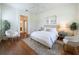 Sunlit bedroom with hardwood floors, a ceiling fan, and neutral décor, creating a relaxing atmosphere at 101 Flame Vine Way, Groveland, FL 34736