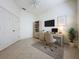 Well-lit home office space with neutral colors, tiled floors, and a dedicated workspace at 101 Flame Vine Way, Groveland, FL 34736