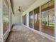 Relaxing screened patio features a ceiling fan, brick floors, and natural light at 101 Flame Vine Way, Groveland, FL 34736
