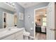 A bathroom offers a single vanity, toilet, and entry to the bedroom at 1132 Hill Mount Dr, Minneola, FL 34715