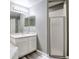 This bathroom features a single vanity, shower and tub, and light gray walls at 1132 Hill Mount Dr, Minneola, FL 34715