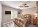 A bedroom features a ceiling fan and light-blocking window blinds at 1132 Hill Mount Dr, Minneola, FL 34715
