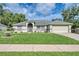 Charming single-story home with a well-manicured lawn, attached two car garage, and inviting entryway at 1132 Hill Mount Dr, Minneola, FL 34715